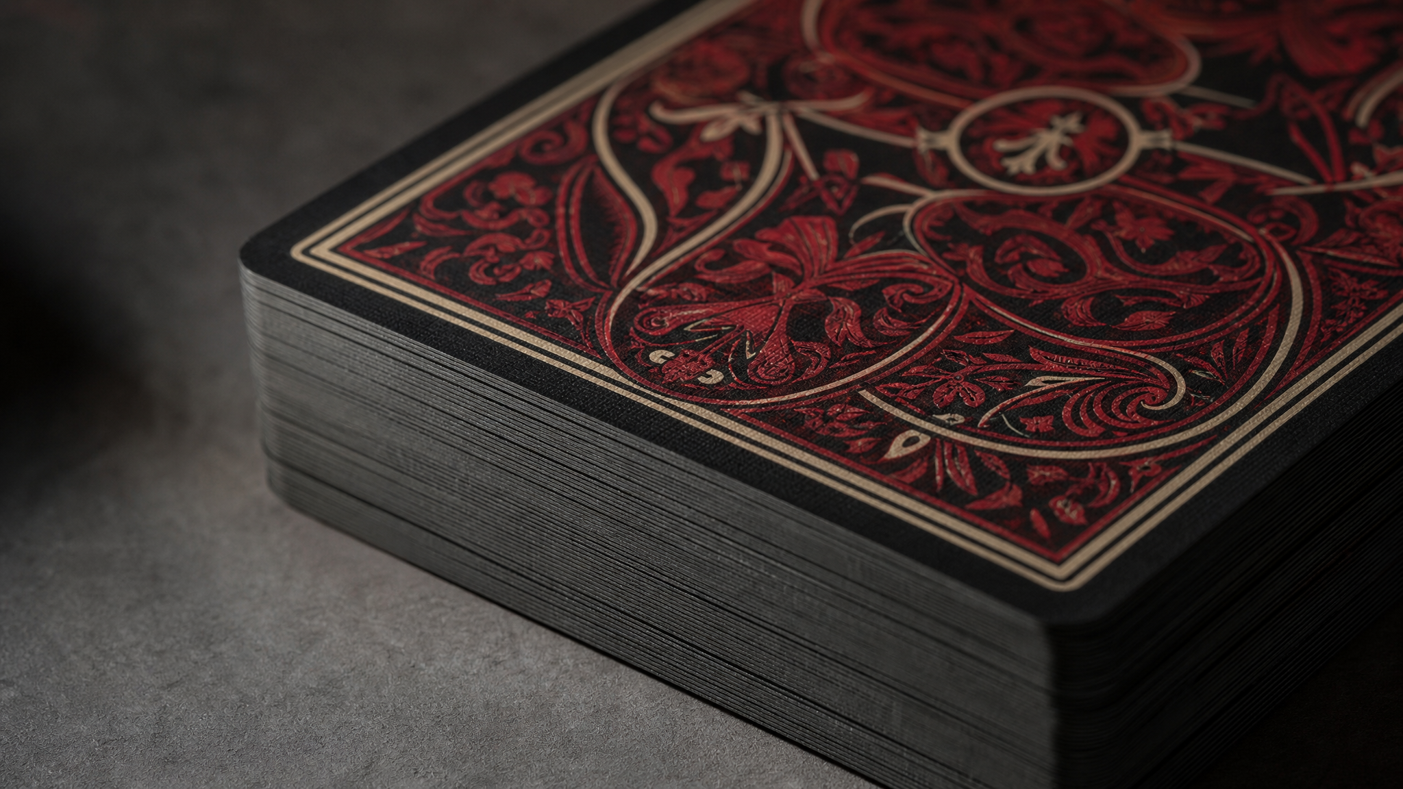 Stacked card deck showing dark paper core and tactile linen finish under angled light