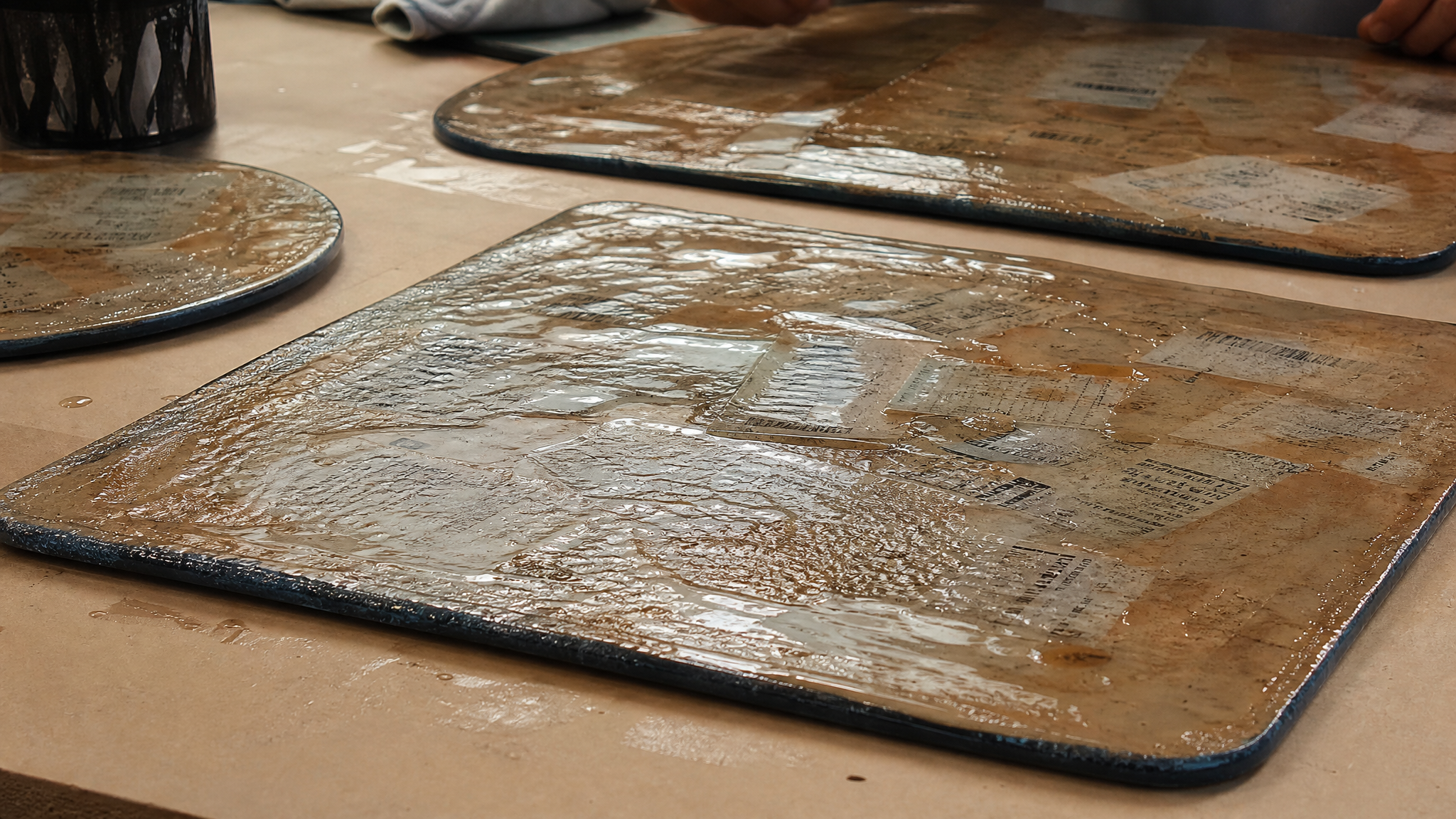 Close view of a laminated placemat with partially shifted receipt ink and irregular textured edges on a worktable