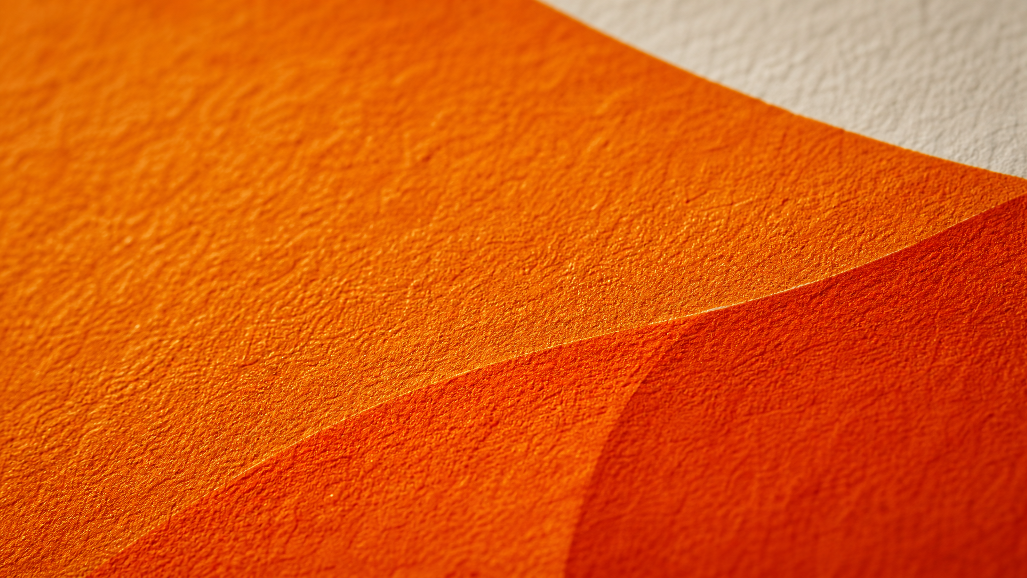 Close view of layered orange print on textured poster paper